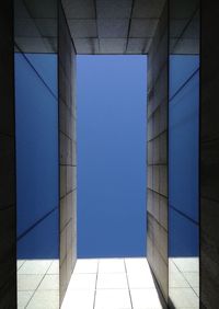 Low angle view of modern building against blue sky