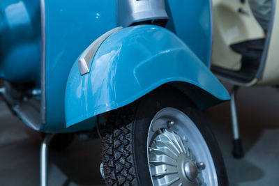 Close-up of scooters parked at shop