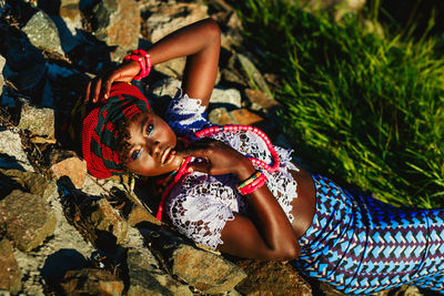 Portrait of model lying on rocks