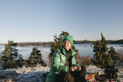 Woman preparing food outdoors at winter