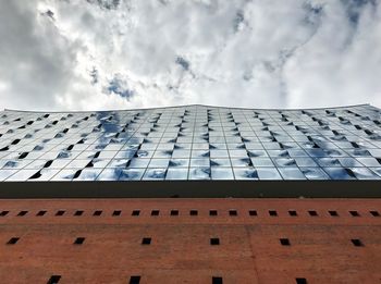 Low angle view of building against cloudy sky