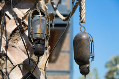 Low angle view of electric lamp hanging on street