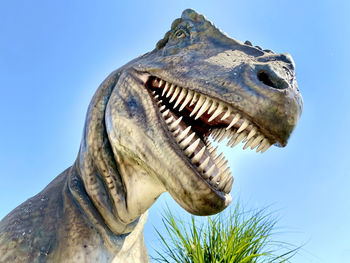 Close-up of animal sculpture against clear sky