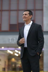 Full length of a man standing in front of office