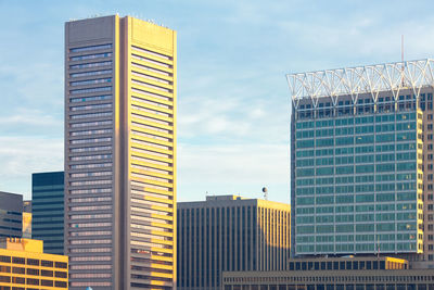 Low angle view of modern buildings against sky in city