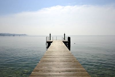 Pier over sea against sky