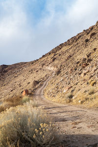 Dirt road up hillside in desert valley