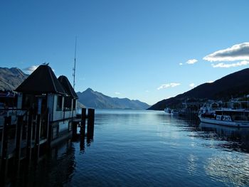 Scenic view of lake and houses against sky