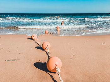 Boy on beach by sea against sky