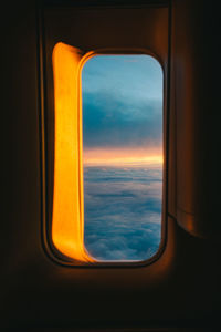 View of cloudscape seen through airplane window