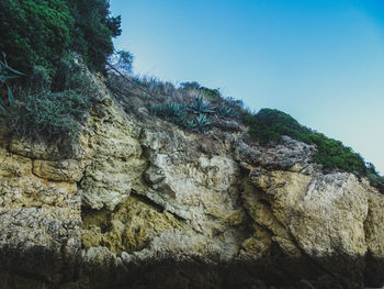 Low angle view of rock formations against sky