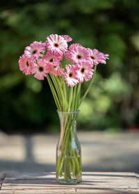 Close-up of pink flower vase on table