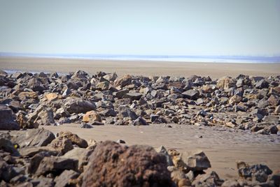 Rocks on beach against sky