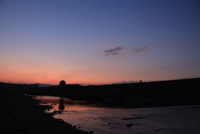 Silhouette people on beach against sky during sunset