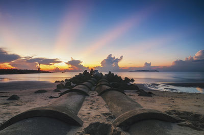 Scenic view of beach against sky during sunset