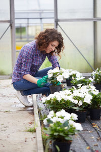 Woman with potted plants at nursery