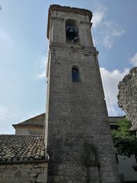 Low angle view of bell tower against sky