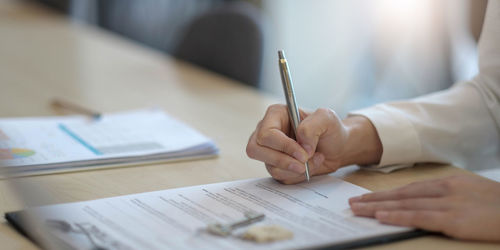 Midsection of man working on table