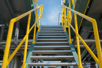 Low angle view of metallic steps against sky