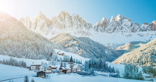 The small village val di funes covered in snow, with dolomites mountains, south tyrol, italy.