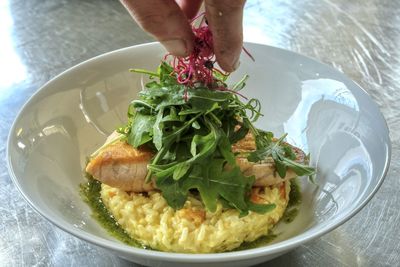 Midsection of person having food in plate