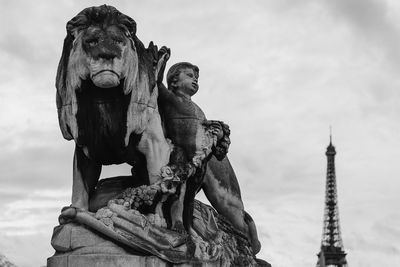 Low angle view of statue against cloudy sky