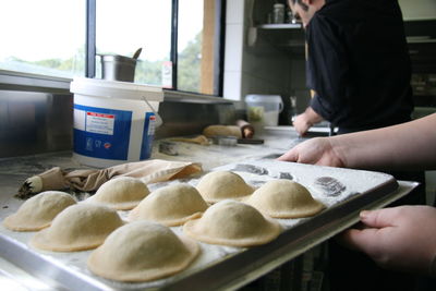 Midsection of person preparing food at kitchen