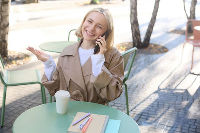 Portrait of young woman using mobile phone