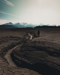 Man standing on field against sky