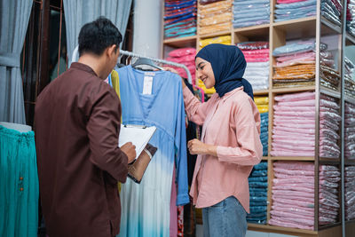 Rear view of couple standing in store