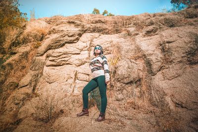 Full length of man standing on rock