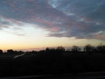 Scenic view of landscape against sky at sunset