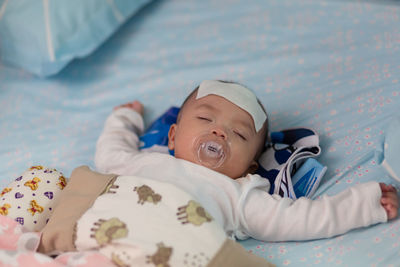 Portrait of cute baby lying on bed