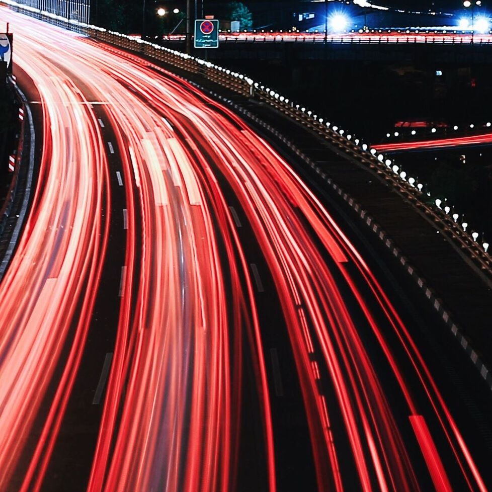 illuminated, night, long exposure, light trail, red, multi colored, motion, speed, blurred motion, transportation, road, lighting equipment, city, glowing, light - natural phenomenon, no people, street, outdoors, high angle view, colorful