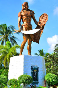 Low angle view of statue against blue sky