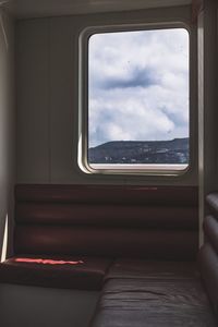 Low angle view of train window against sky