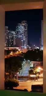 High angle view of illuminated buildings against sky at night