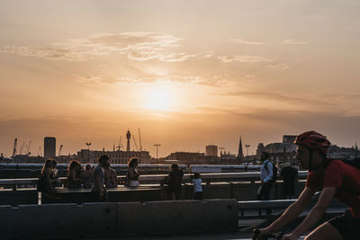 Group of people in city during sunset