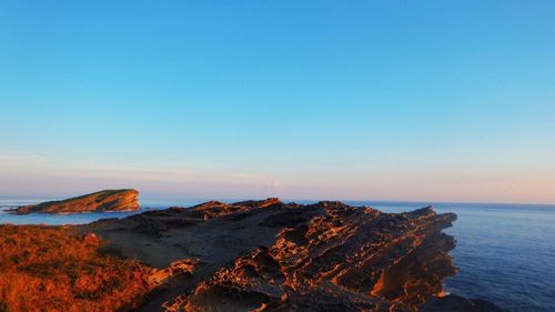 Scenic view of sea against clear blue sky
