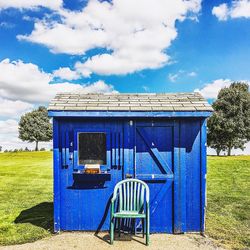 Built structure on field against blue sky