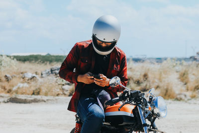 Rear view of man riding custom bike 