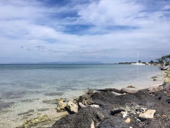 Scenic view of sea against cloudy sky