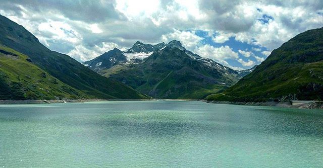 mountain, mountain range, water, tranquil scene, scenics, sky, tranquility, beauty in nature, lake, cloud - sky, nature, cloud, waterfront, idyllic, river, landscape, non-urban scene, cloudy, tree, day