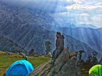 Rear view of people on mountain against sky