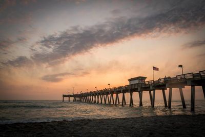 Silhouette pier on sea against sky during sunset