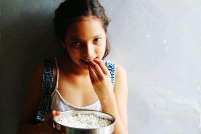 Portrait of young woman eating food