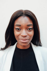 Portrait of smiling woman against white background