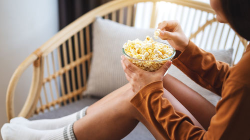 Cropped hand of woman holding food