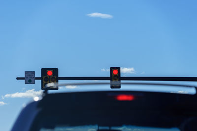 Road sign against blue sky