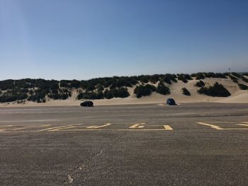 Scenic view of road against clear blue sky